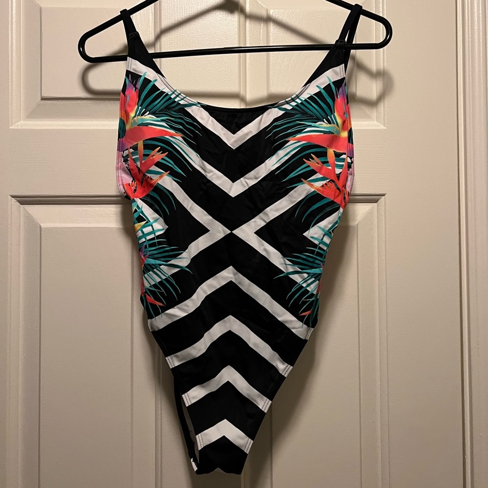 Never been worn, size M, open back one piece swim suit